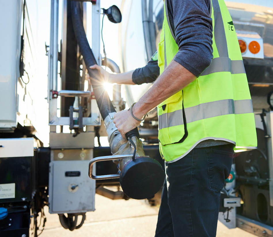 man in vest refueling the station.